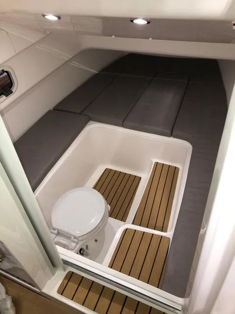 Slide: The Image of 2020 Zar Formenti 85 SL boat interior with toilet and cushioned seating. - 13