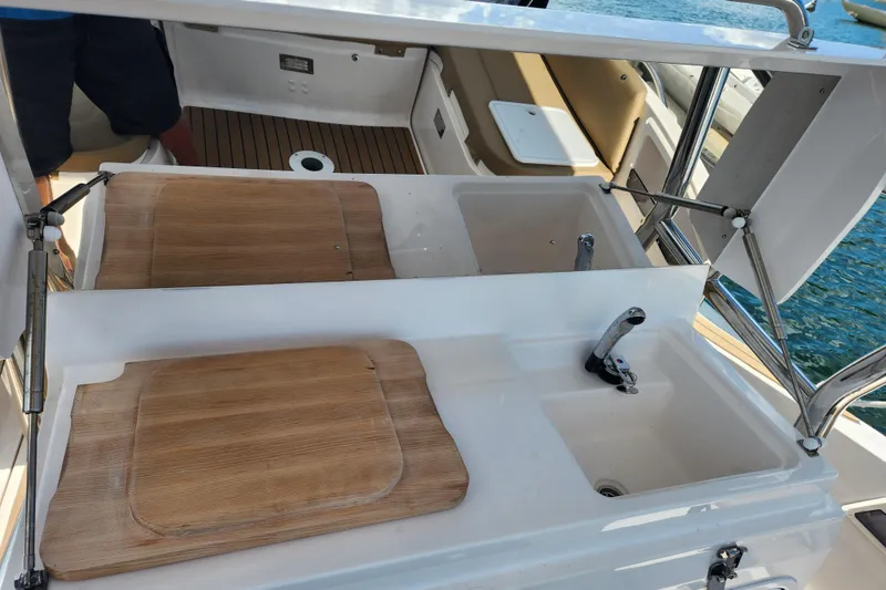 Slide: The Image of Outdoor kitchen area on a 2020 Zar Formenti 85 SL boat with wooden covers. - 18