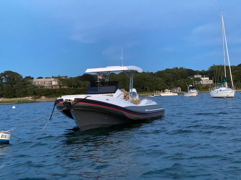 Slide: The Image of 2020 Zar Formenti 85 SL boat anchored on calm water with scenic background. - 2