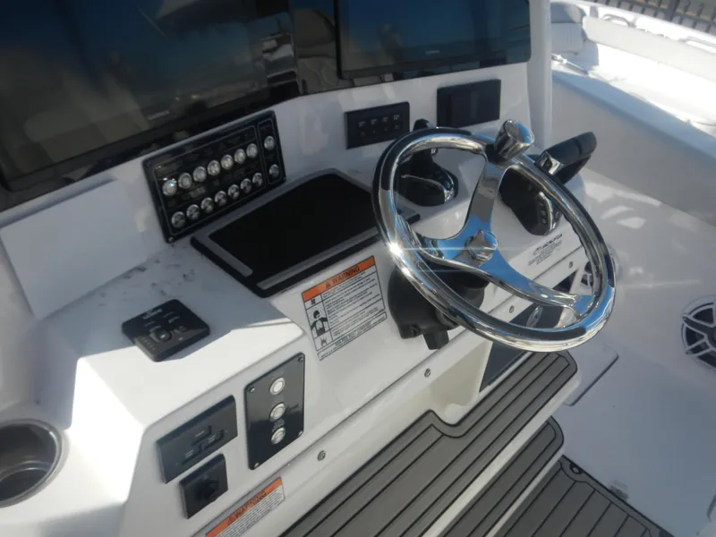 Slide: The Image of 2024 Sea Fox 328 Commander helm with modern controls and steering wheel. - 12
