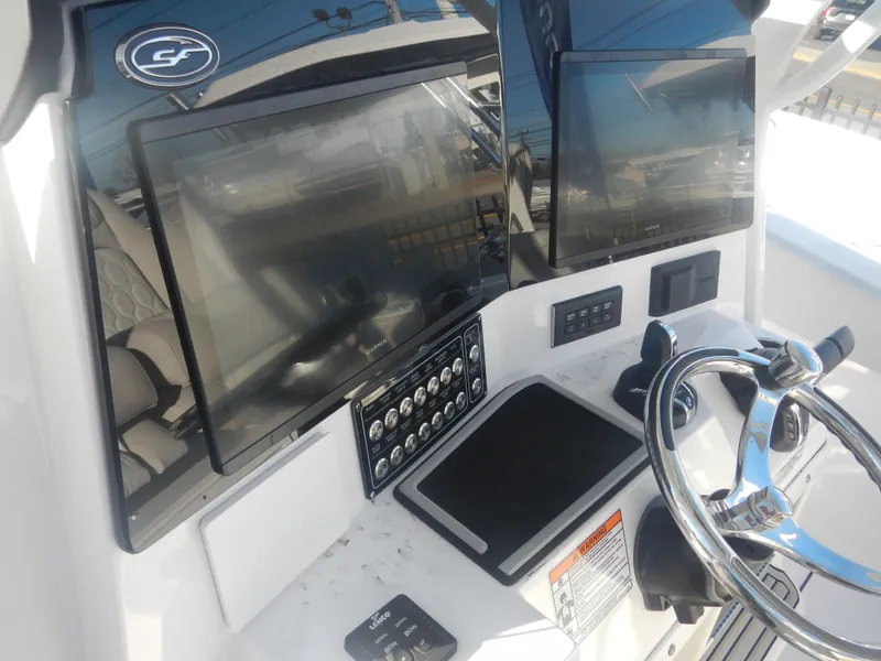 Slide: The Image of 2024 Sea Fox 328 Commander helm with dual displays and steering wheel. - 13