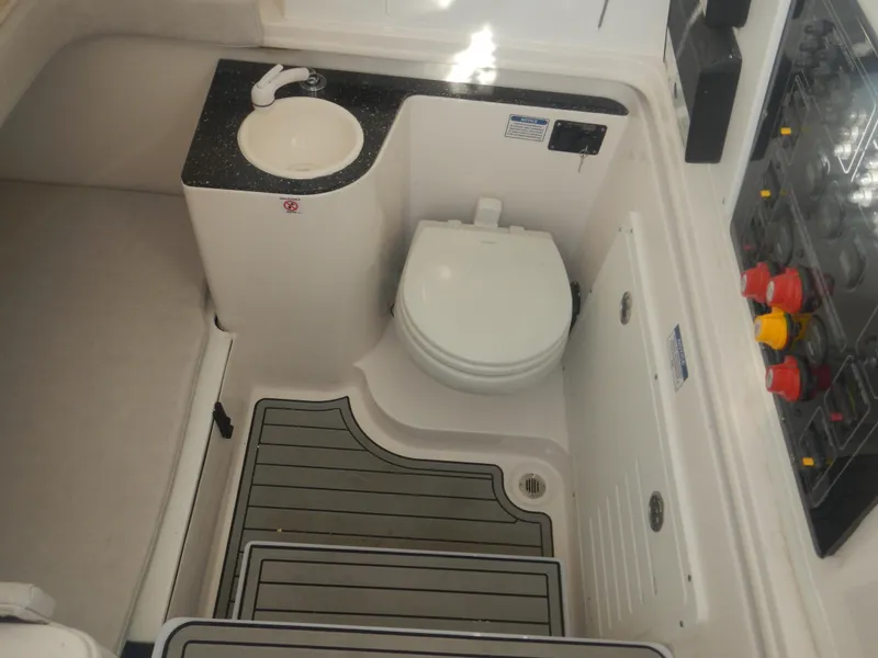 Slide: The Image of 2024 Sea Fox 328 Commander boat bathroom with toilet, sink, and storage. - 19
