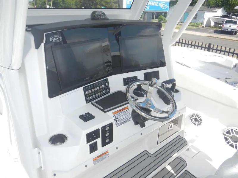 Slide: The Image of 2024 Sea Fox 328 Commander boat helm with dual screens and modern controls. - 23