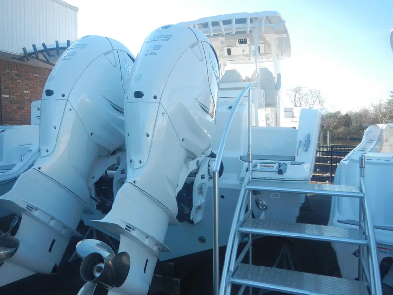 Slide: The Image of 2024 Sea Fox 328 Commander with dual outboard engines and rear access ladder. - 3