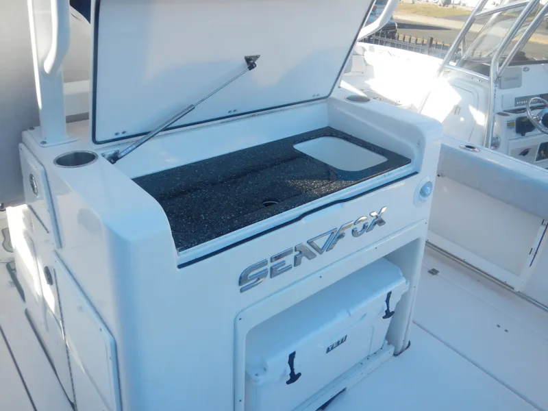 Slide: The Image of 2024 Sea Fox 328 Commander boat with open storage compartment. - 6