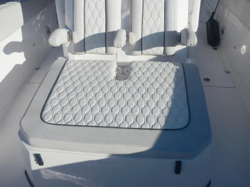 Slide: The Image of 2024 Sea Fox 328 Commander boat seating with white hexagonal pattern upholstery. - 7
