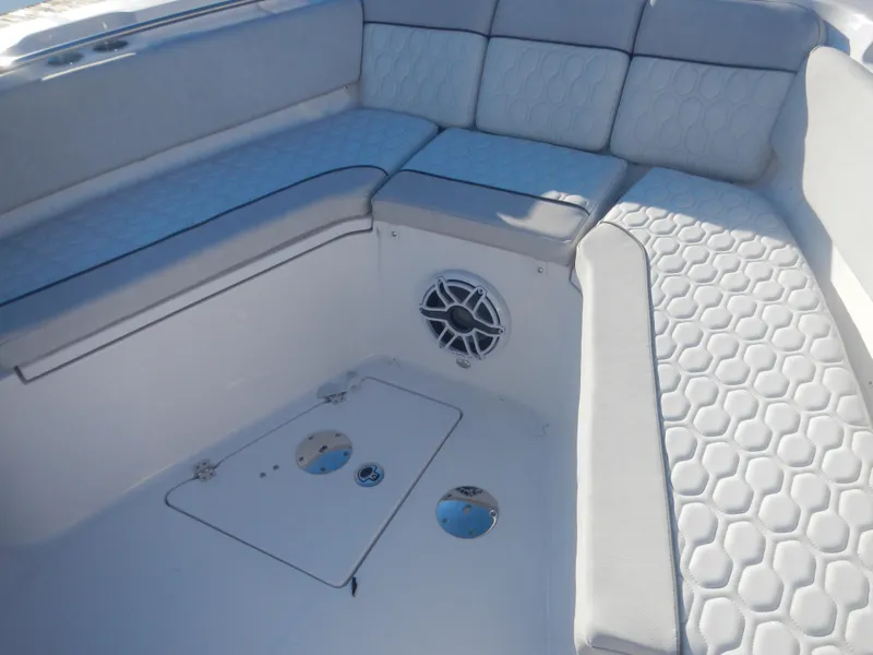 Slide: The Image of 2024 Sea Fox 328 Commander boat interior with cushioned seating and speaker. - 9