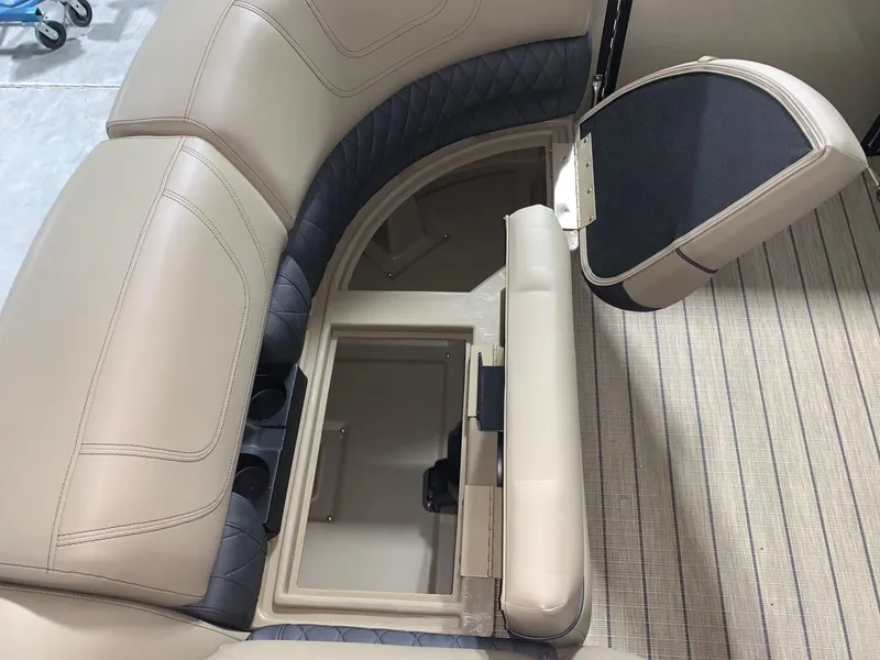 Slide: The Image of 2024 Starcraft SLS 3 Q DH boat with open storage compartment in beige seating. - 10