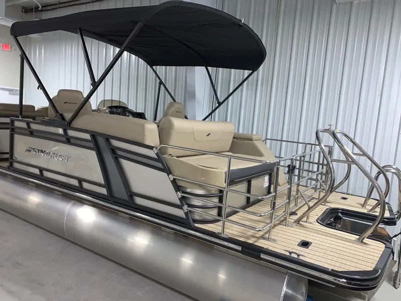 Slide: The Image of 2024 Starcraft SLS 3 Q DH pontoon boat with canopy in showroom. - 2