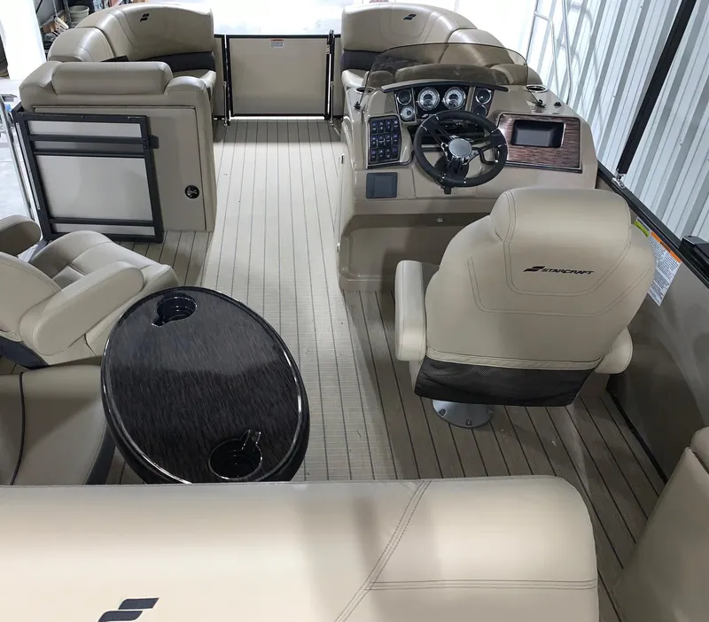 Slide: The Image of 2024 Starcraft SLS 3 Q DH boat interior with beige seating and modern dashboard. - 3