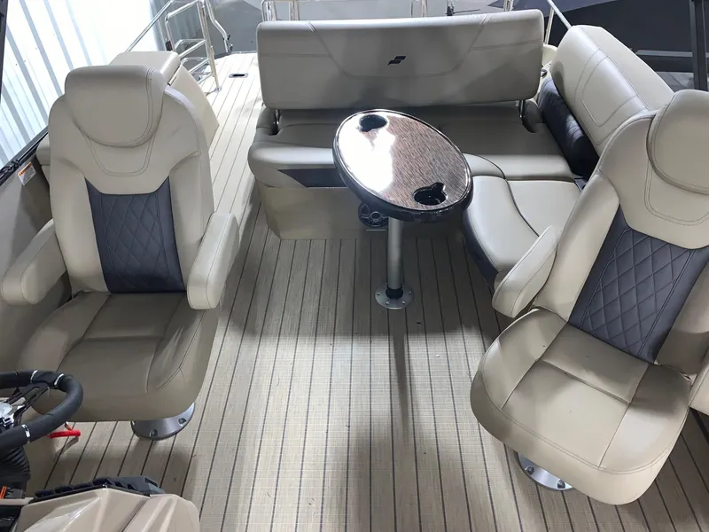 Slide: The Image of 2024 Starcraft SLS 3 Q DH boat interior with beige seating and a central table. - 4
