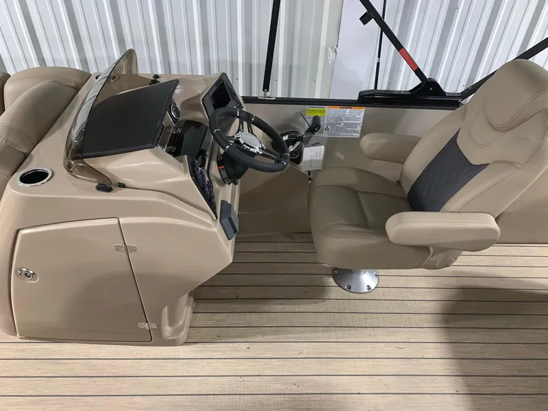 Slide: The Image of 2024 Starcraft SLS 3 Q DH boat helm with beige captain's chair and control panel. - 8