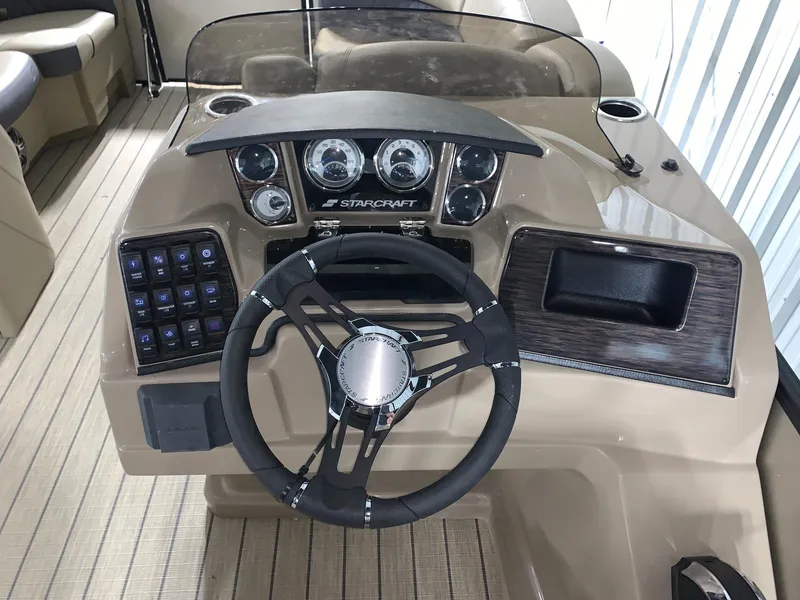Slide: The Image of 2024 Starcraft SLS 3 Q DH boat dashboard with steering wheel and control panel. - 9