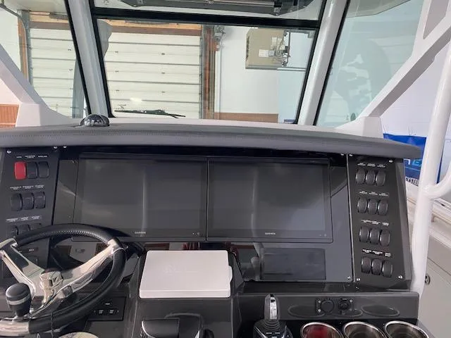 Slide: The Image of 2023 Blackfin 332 CC boat dashboard with dual screens and control panel. - 5