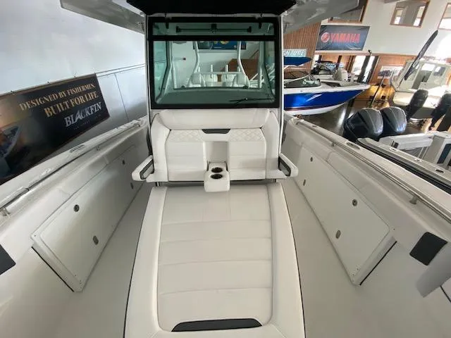 Slide: The Image of 2023 Blackfin 332 CC center console boat interior with white seating and storage compartments. - 7
