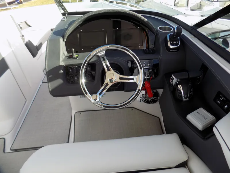 Slide: The Image of 2023 Regal 29 OBX boat cockpit with steering wheel and control panel. - 15