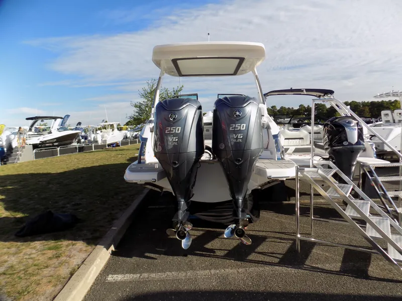 Slide: The Image of 2023 Regal 29 OBX boat with dual Yamaha 250 V6 outboard engines displayed outdoors. - 2