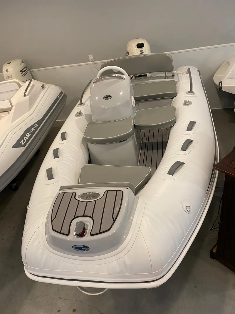 Slide: The Image of 2022 Grand G380 inflatable boat with gray seating and white exterior in showroom. - 3