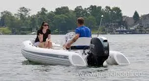 Slide: The Image of 2022 Grand G380 inflatable boat on a lake with two people onboard. - 5
