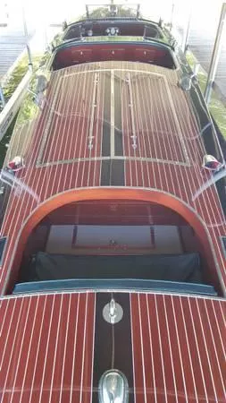 Slide: The Image of 1989 Hacker-Craft Triple Cockpit boat with polished wood finish and classic design. - 10