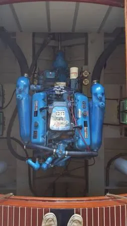 Slide: The Image of 1989 Hacker-Craft Triple Cockpit engine, showcasing detailed blue mechanical components. - 16