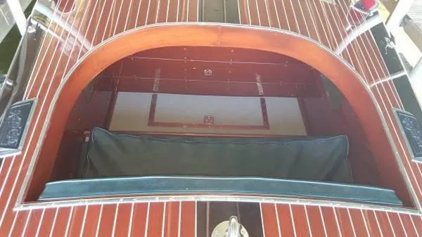 Slide: The Image of 1989 Hacker-Craft Triple Cockpit boat with polished wood finish and green upholstery. - 19