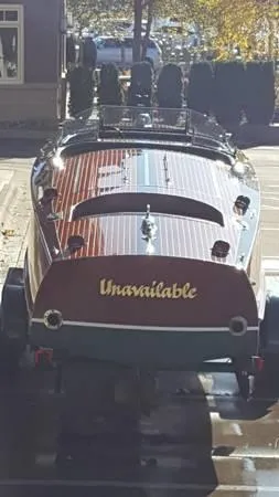 Slide: The Image of 1989 Hacker-Craft Triple Cockpit boat with "Unavailable" on stern, parked on trailer. - 28