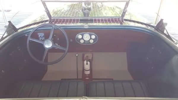 Slide: The Image of 1989 Hacker-Craft Triple Cockpit interior with classic steering wheel and dashboard gauges. - 30