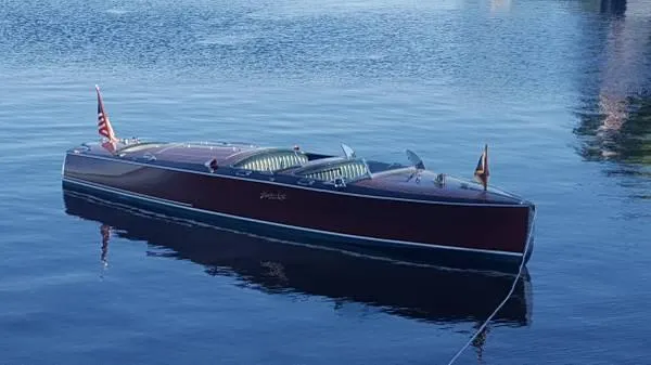 Slide: The Image of 1989 Hacker-Craft Triple Cockpit boat on calm water, showcasing classic wooden design. - 4