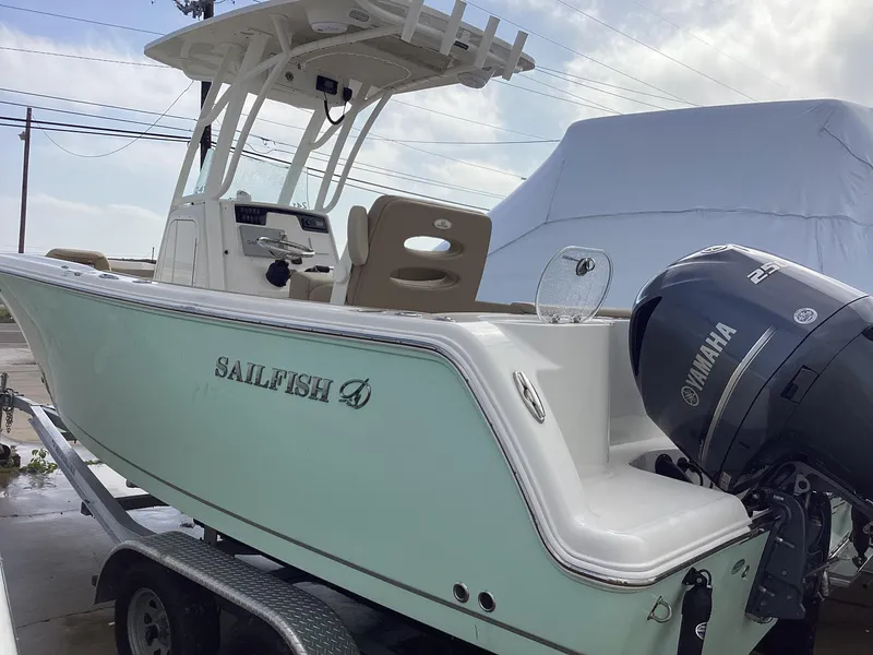 Slide: The Image of 2021 Sailfish 241CC boat with Yamaha engine on trailer, side view. - 1