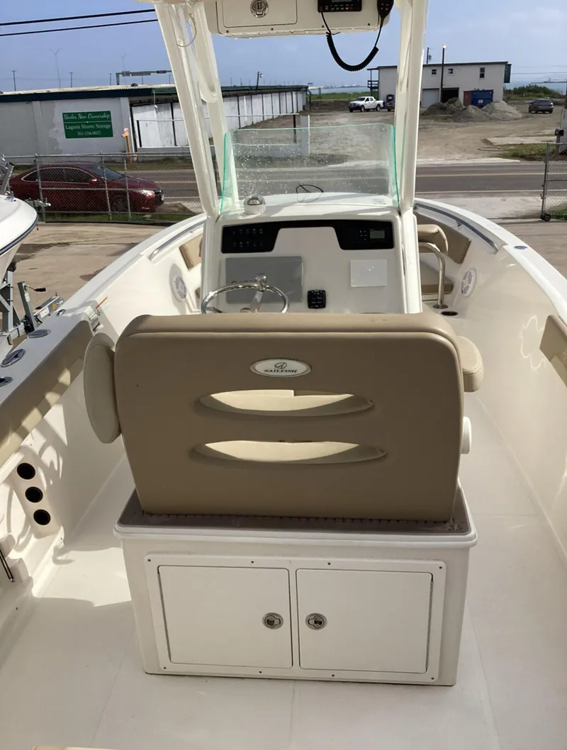 Slide: The Image of 2021 Sailfish 241CC boat interior with beige seating and storage compartments. - 3