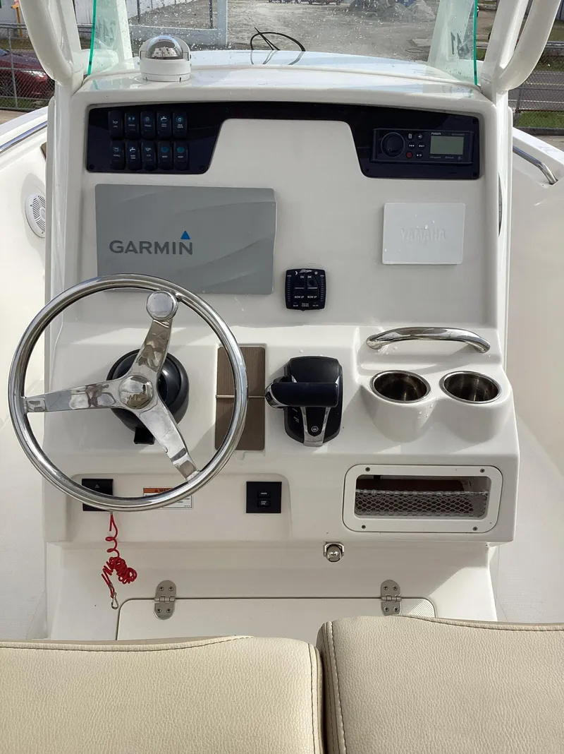 Slide: The Image of 2021 Sailfish 241CC boat dashboard with Garmin navigation system and steering wheel. - 5