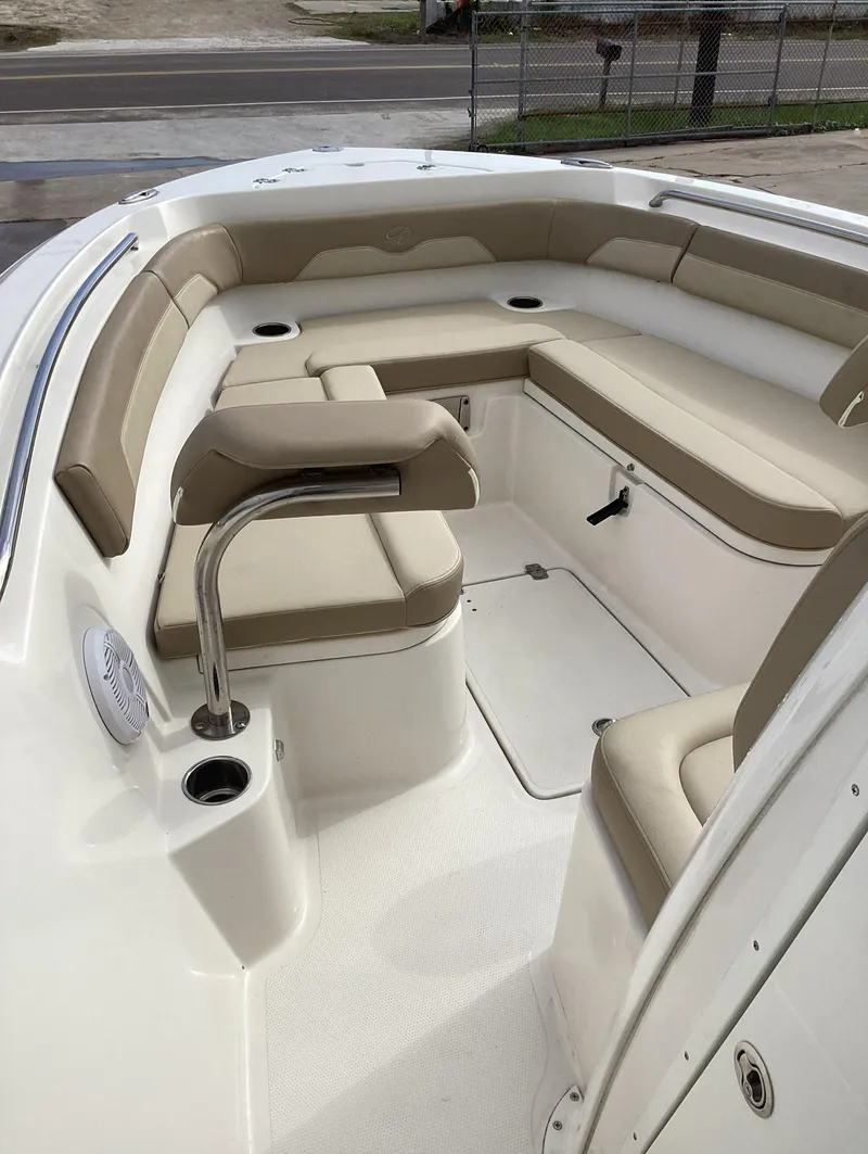 Slide: The Image of 2021 Sailfish 241CC boat interior with beige seating and cup holders. - 9