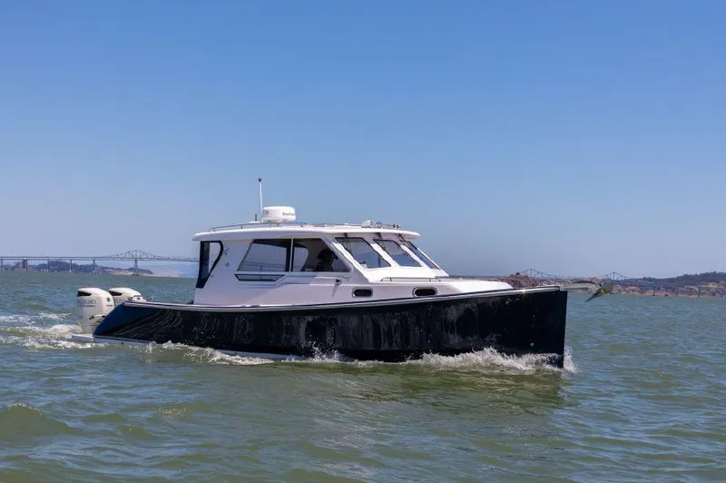 Slide: The Image of True North 34 boat cruising on water, 2020 model, clear sky background. - 0