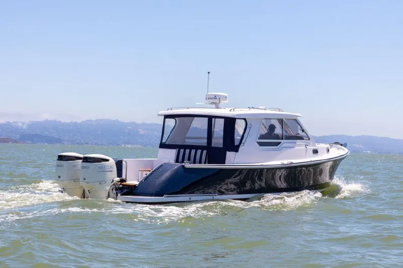 Slide: The Image of 2020 True North 34 boat cruising on open water with twin outboard engines. - 1