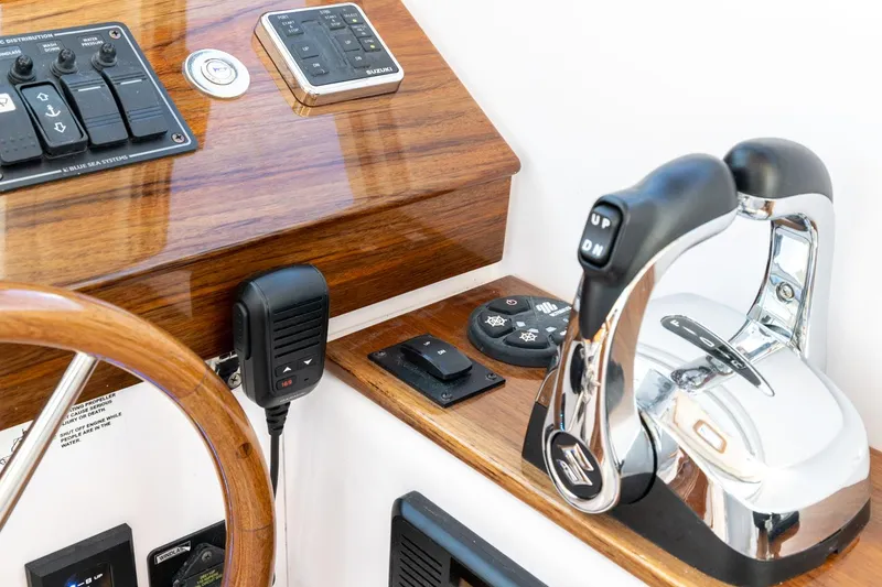 Slide: The Image of Control panel of a 2020 True North 34 boat with wooden accents and modern controls. - 12