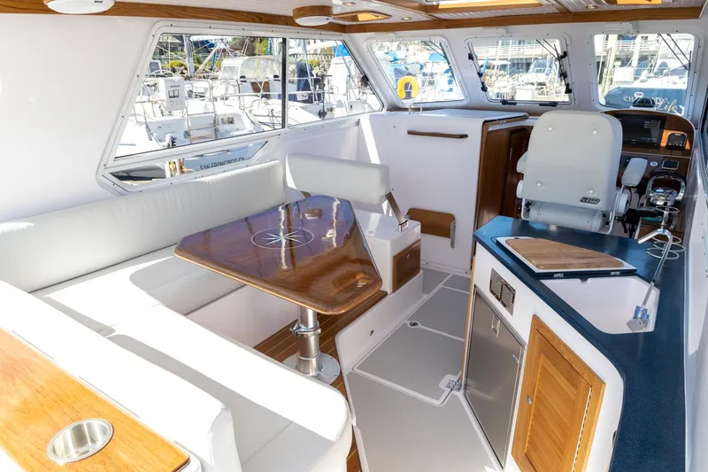 Slide: The Image of Interior of 2020 True North 34 boat with seating, table, and helm station. - 13