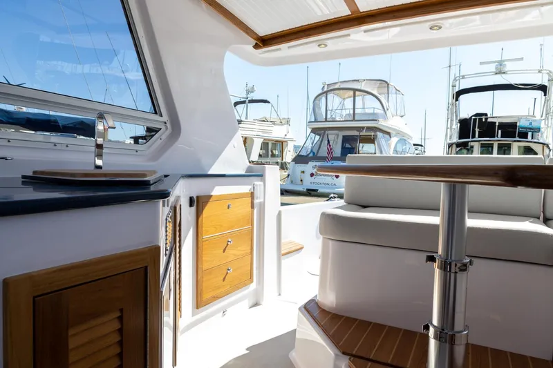 Slide: The Image of Interior view of 2020 True North 34 yacht with docked boats in background. - 14