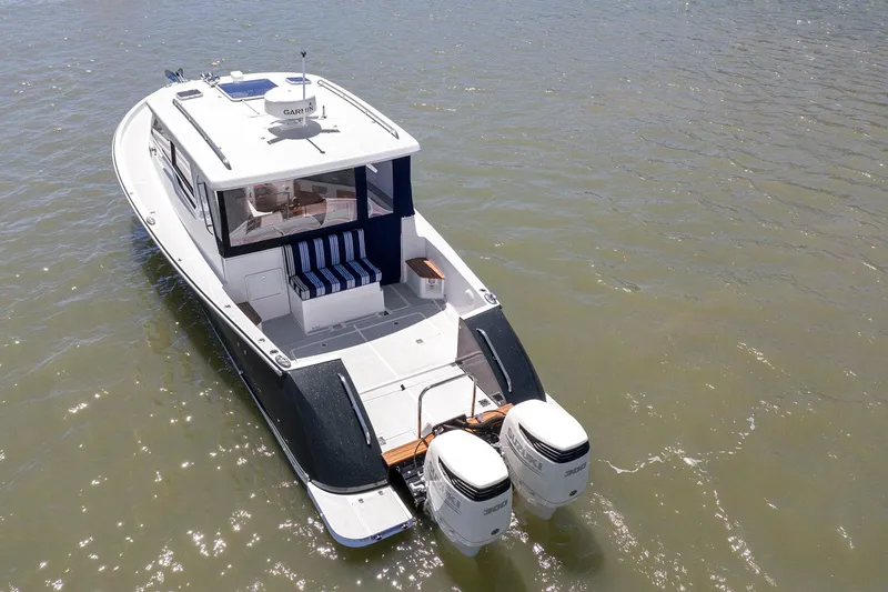 Slide: The Image of 2020 True North 34 boat with dual outboard motors on water. - 3