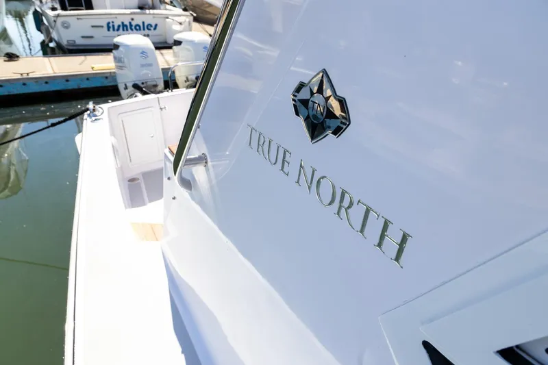 Slide: The Image of True North 34 boat, 2020 model, docked at marina with clear branding. - 5