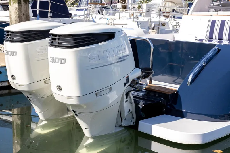 Slide: The Image of Twin Suzuki 300 outboard engines on a 2020 True North 34 boat at a marina. - 9