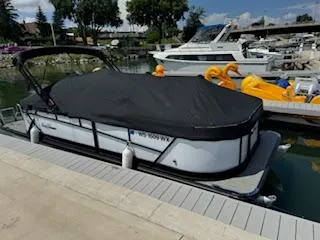 Slide: The Image of 2021 SunChaser Geneva Sport 22 LR DH pontoon boat docked with cover. - 1
