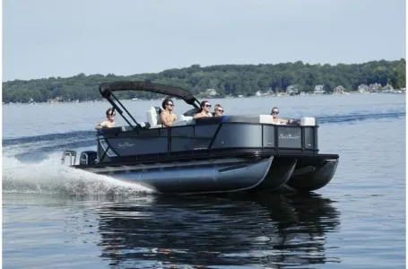 Slide: The Image of 2021 SunChaser Geneva Sport 22 LR DH pontoon boat cruising on a lake. - 16