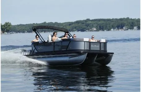 Slide: The Image of 2021 SunChaser Geneva Sport 22 LR DH pontoon boat cruising on a lake. - 19