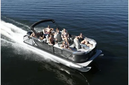 Slide: The Image of 2021 SunChaser Geneva Sport 22 LR DH pontoon boat cruising on a lake with passengers. - 25