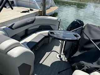 Slide: The Image of 2021 SunChaser Geneva Sport 22 LR DH pontoon boat interior with seating and table. - 4