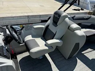 Slide: The Image of 2021 SunChaser Geneva Sport 22 LR DH boat interior with plush captain's chair. - 6
