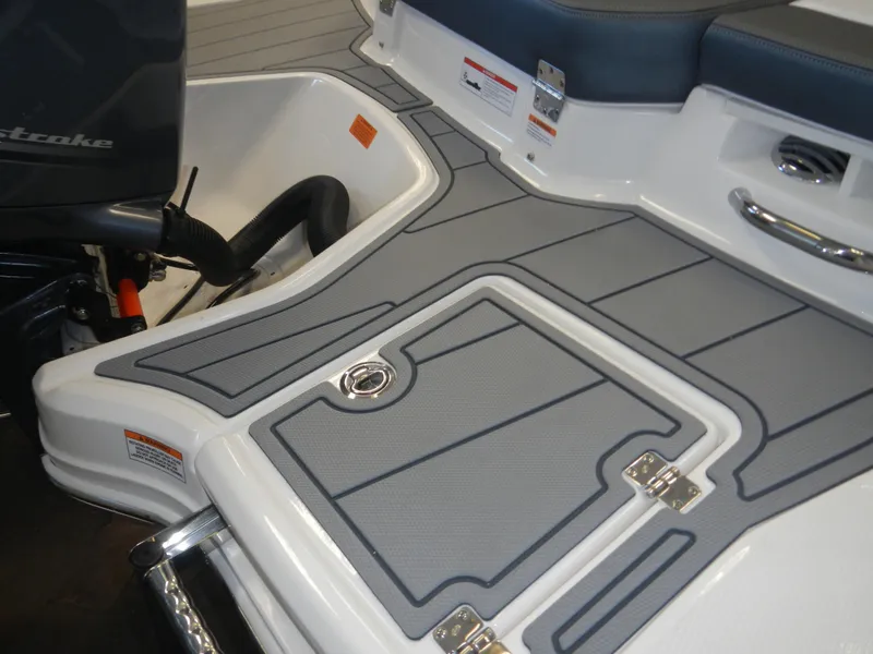 Slide: The Image of 2024 Chaparral 21 SSi boat deck with storage compartment and motor. - 3