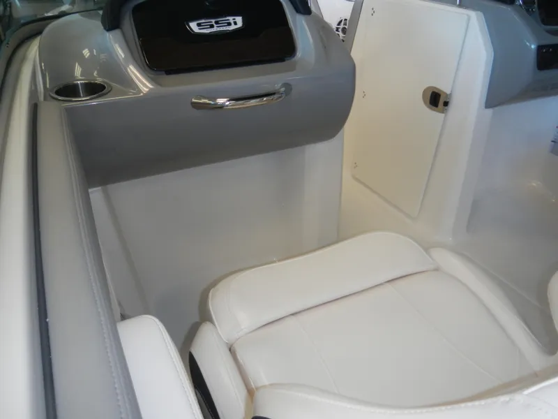 Slide: The Image of 2024 Chaparral 21 SSi boat interior with white seating and storage compartments. - 4