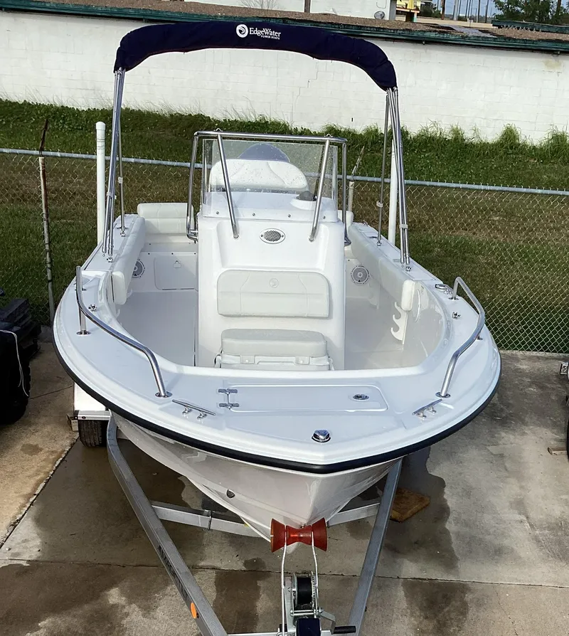 Slide: The Image of 2023 Edgewater 188CC boat on trailer with blue canopy. - 10